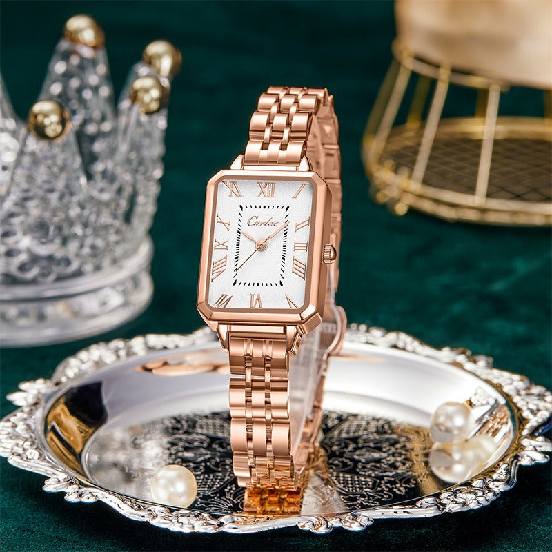 Rose gold tank watch with a white face on a white background